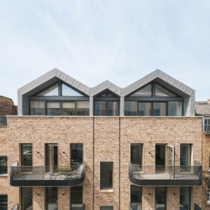 Rear view of 12-13 Greek Street. Image shows the slate tile and zinc clad mansard roof and curved steel balconies.